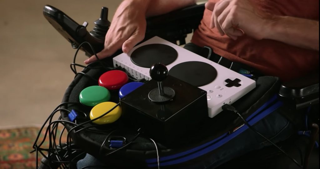 Close up view of a Trabasack Curve Connect upon Zach Anner's lap, with a XAC, Buddy Buttons and Joystick