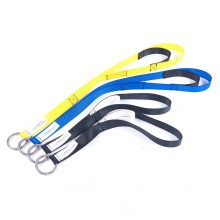Image shows 4 hoist straps, in yellow, blue and black, lay on a white surface