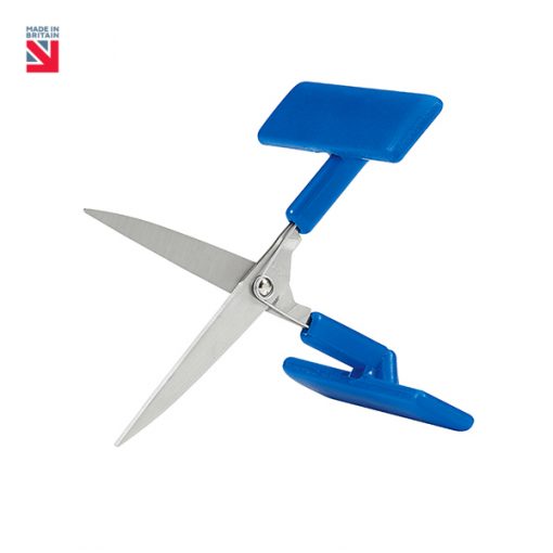 Image is a photograph of the Peta UK table top scissors in an open position, with blue t-shaped handle on a white background. In the top lefthand corner of the image there is a small Union Flag logo with text that reads "Made in Britain".