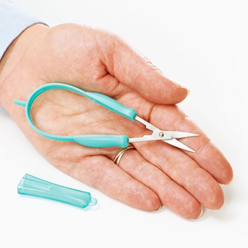 Image is a photograph of a pair of mini easi-grip scissors in palm of an open hand.