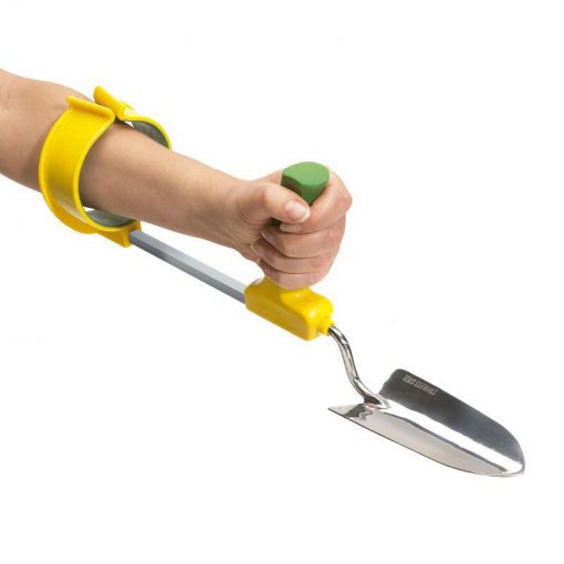 Image is a photograph of an extended arm wearing a easi-grip arm cuff support with a trowel attached to the end