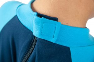 Image shows a photograph of the back of a boy's neck, wearing the Seenin sleepsuit in navy and turquoise, to illustrate the hidden zip area
