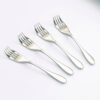 Image is a photograph of 4 stainless steel Knorks on a white background