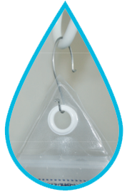 Image is a photograph in a teardrop shape, showing a close-up of the Water Drop being hung from a metal hook