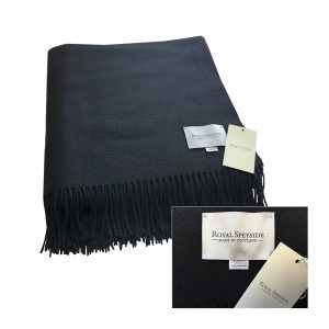 Image is a photograph of a black woollen blanket with created by Royal Speyside - Made in Scotland