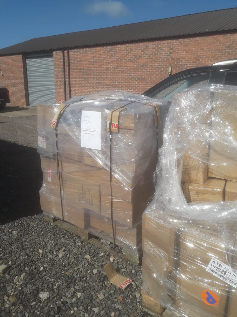 Pallets of newly arrived Trabasack Curve stock outside the warehouse before unloading.