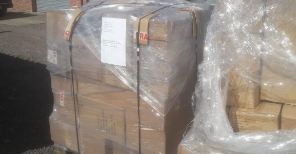 Pallets of newly arrived Trabasack Curve stock outside the warehouse before unloading.